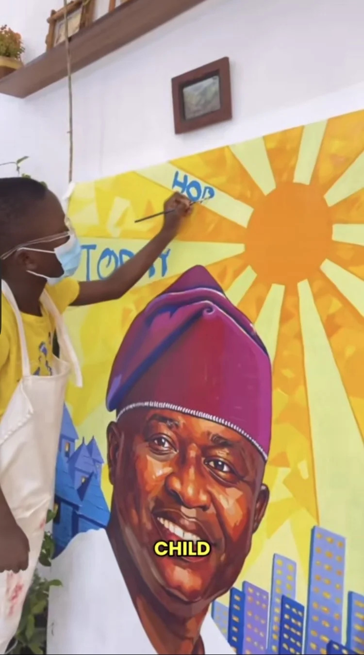 Seven-year-old Nigerian artist Kendis presenting his viral portrait